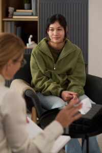 young woman listening to therapist in a meeting
