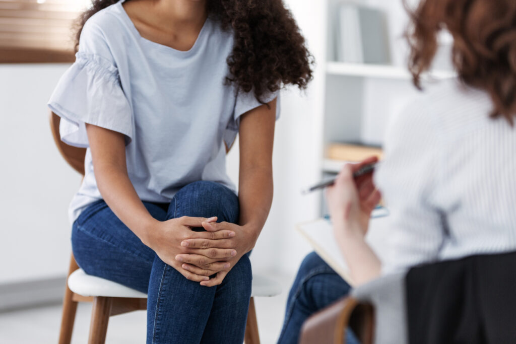 a young woman speaking with her therapist